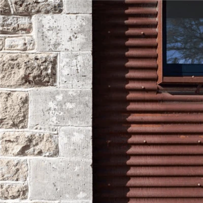 Corrugated corten rusted roof panel installation